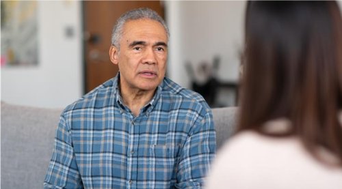 Bilde av en mann i samtale med en person